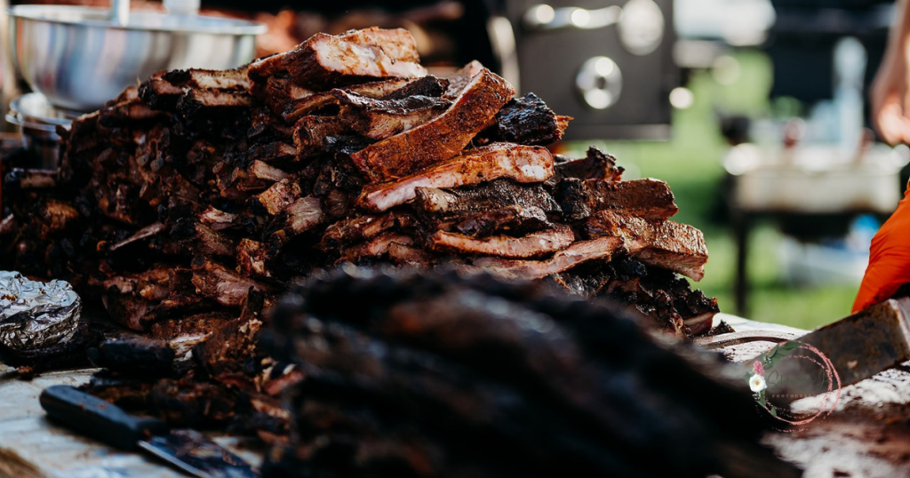 Bunch of ribs placed on a cutting board at the 12 Bridges Rib Cook-Off Competition shot by Sharilyn J Photography.