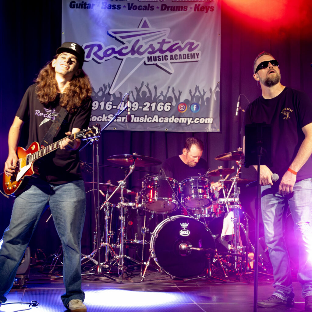 Main stage signage showcasing 12 Bridges Rib Cook-Off sponsorship partners during the event.