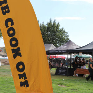 Event entrance signage welcoming guests and recognizing 12 Bridges Rib Cook-Off sponsorship support.
