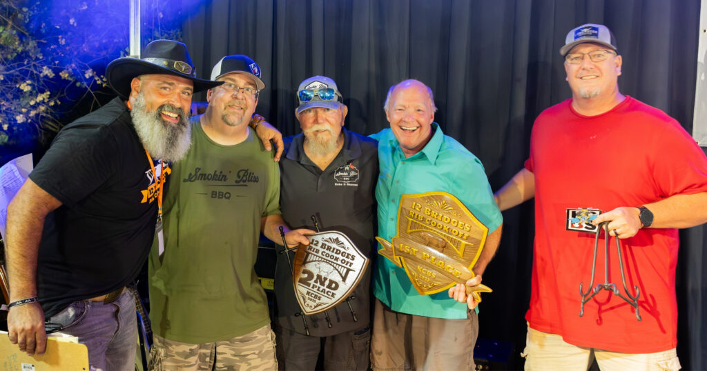 Winning rib cook-off teams celebrating at the 12 Bridges Rib Cook-Off in Lincoln, CA