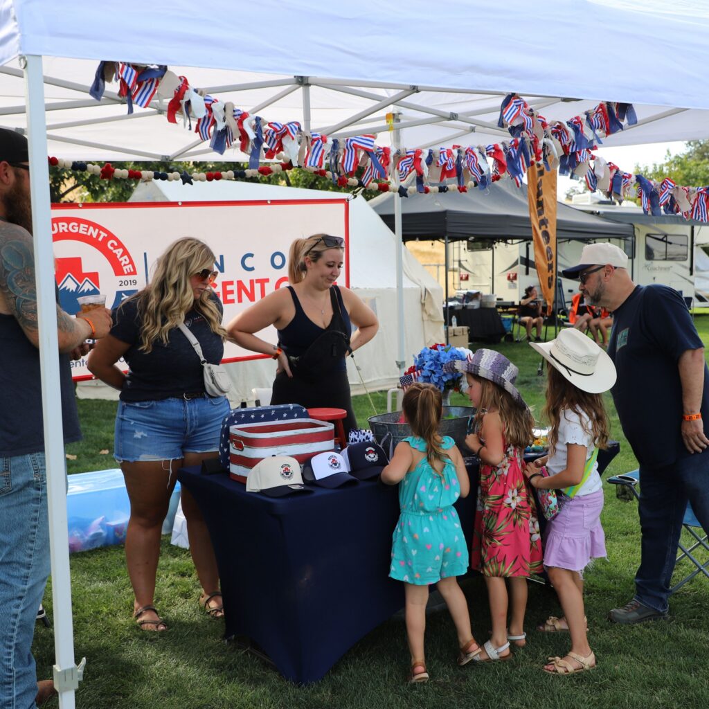 Lincoln Urgent Care signage displayed as a Grand Champion sponsor at the 12 Bridges Rib Cook-Off.